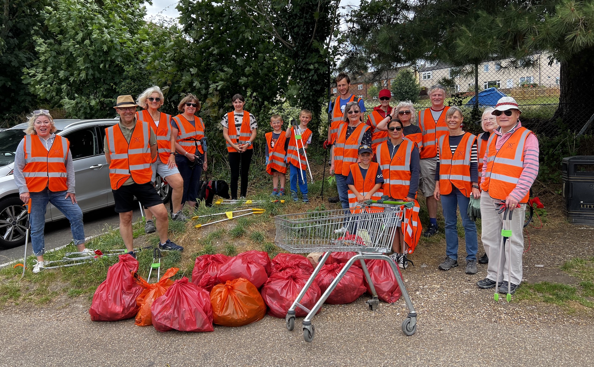 16 litter pickers in hi-viz vests.